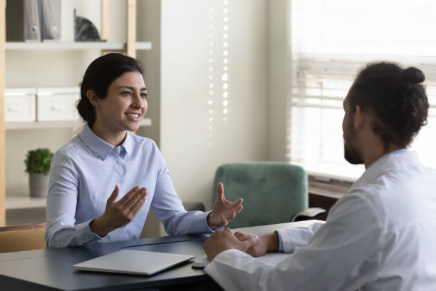 istock Smiling indian patient talking with african doctor. 1337312761