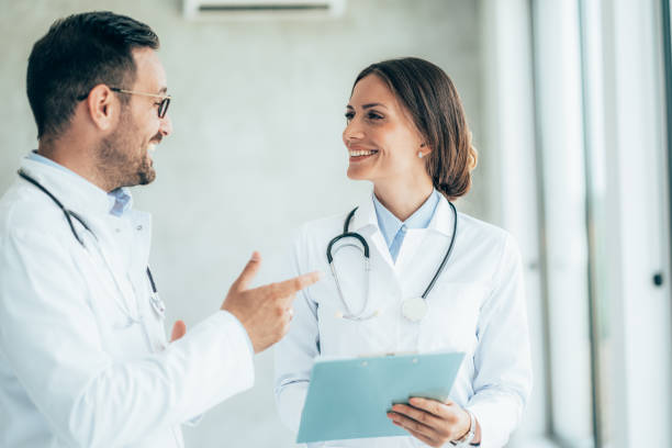 istock Two healthcare workers talking at hospital 1337314956
