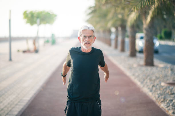 istock Senior man stretching on a running track before jogging 1337316062