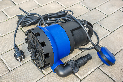 New submersible elektriskpump with a blue plastic housing on a stone floor