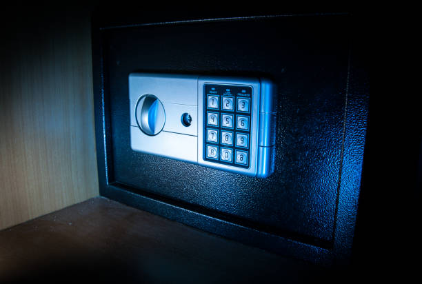 istock Small modern safe on shelf in dark. Small safe box close up in low key light 1337325893