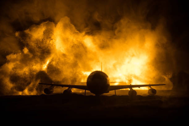 istock Air Crash. Burning falling plane. The plane crashed to the ground. Decorated with toy at dark fire background. Air accident concept. 1337325904