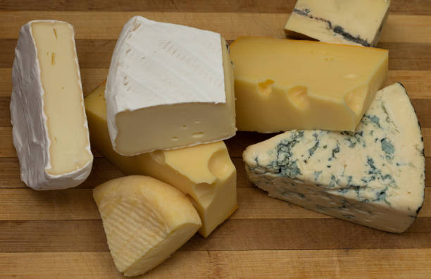 istock Different types of cheese on a rustic wooden cutting board. Top view. 1337327131