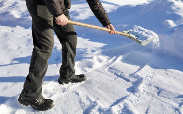 istock Man shoveling snow, raises and throws, on winter day 1337332152
