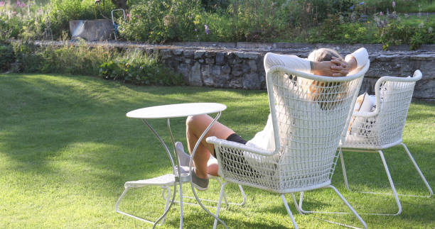 istock Woman relaxes with a book in a garden 1337332259