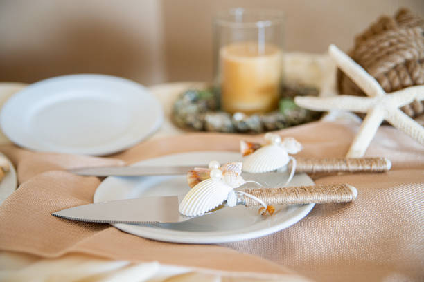 istock Whimsicle cake serving utensils decorated with seashells,starfish and handle wrapped in twinw at wedding cake table 1337332793