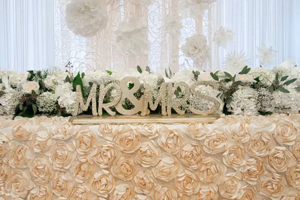 Gold Mr.&Mrs. wood sign on gorgeous sweetheart table at wedding reception