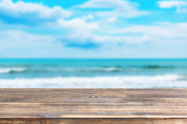 istock wood table top on blur sea wave background 1337333099