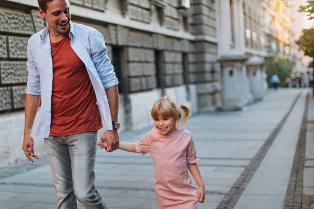 istock Father and daughter walk and talk 1337333131