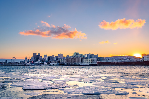 Montreal at sunset in winter, view of the st. Lawrence River covered with ice.
