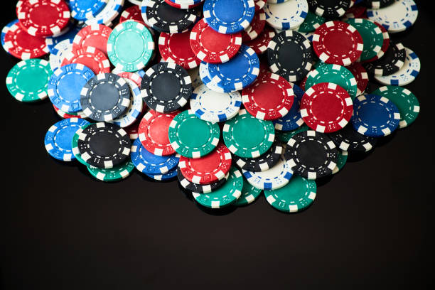 istock Stack of Casino gambling chips isolated on black reflective background 1337335511