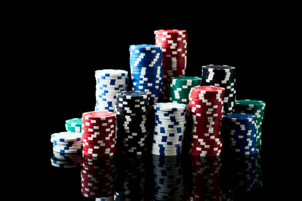 istock Stack of Casino gambling chips isolated on black reflective background 1337335512