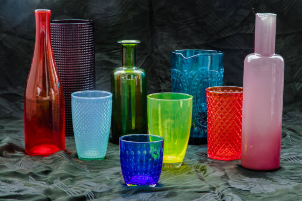istock Many Different glass jar and glass cups and surface reflections on a black background. Group of different glassware. 1337336332