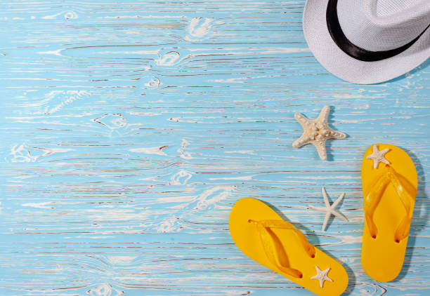 istock yellow rubber flip flops, white beach hat, starfish on a blue wooden background 1337338200