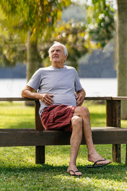 istock Retired senior man sitting in the public park 1337340632