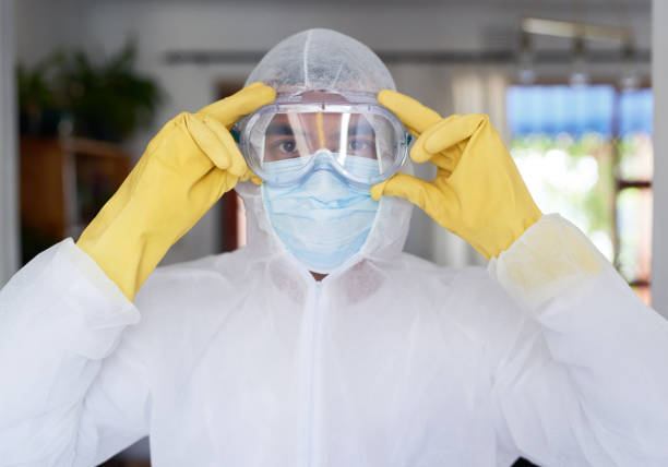 Portrait of a young man in a hazmat suit getting ready to sanitise a house We're at war with this virus biohazard cleanup stock pictures, royalty-free photos & images