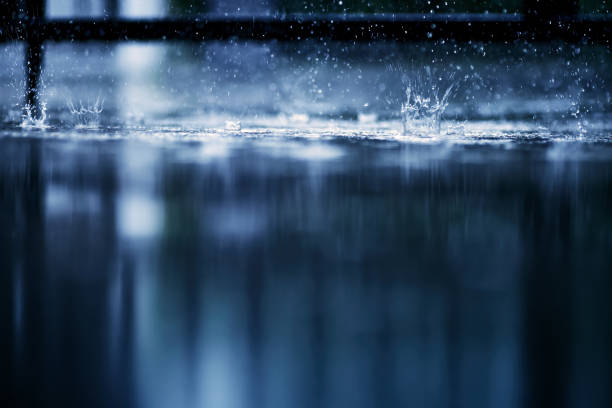 istock heavy raining make many small splash crown from water droplets drop down to the concrete floor in blue tone color scene 1337342371