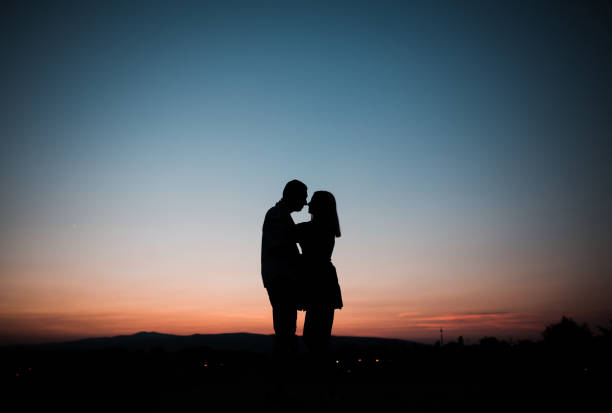 istock Young married couple enjoying the sunset 1337342573