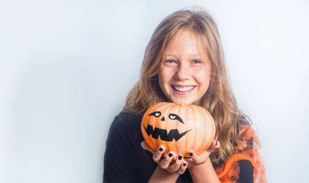 istock Child with Halloween pumpkin 1337342578