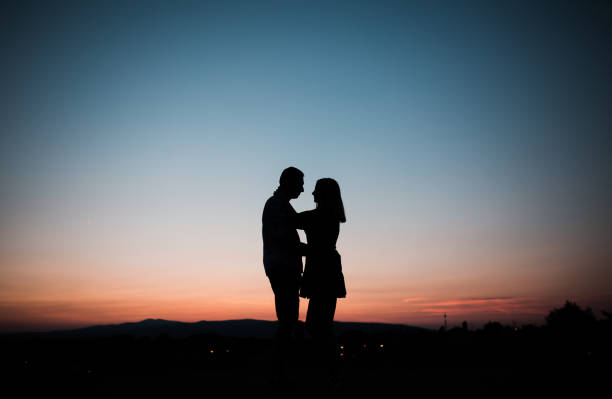 istock The shadow of embracing young married couple 1337344471