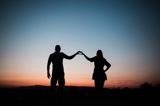 istock Couple in love making heart sign 1337349537