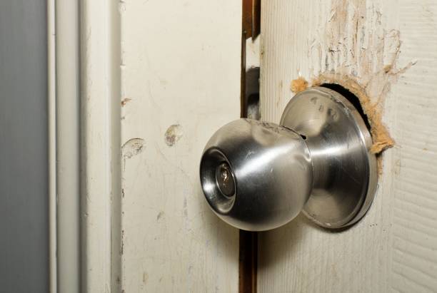 Broken modern doorknob closeup with signs of forced entry, criminal activity. Broken modern doorknob closeup with signs of forced entry, criminal activity and door slightly open. burglary stock pictures, royalty-free photos & images