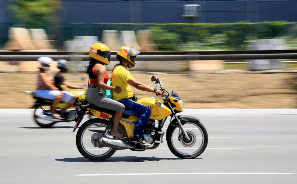 A couple riding their motorcycle in the car-pool lane.