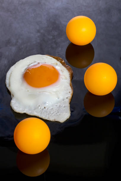 istock Still life with a roasted scrambled eggs and orange balls on an abstract background 1337356795
