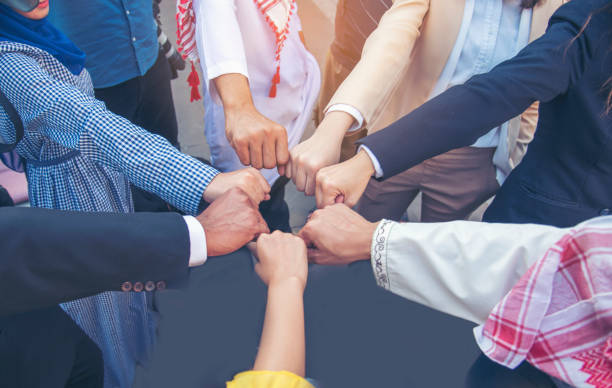 istock Diverse multiethnic Partners hands together teamwork group of multi racial people meeting join hands togetherness. Diversity people hands join empower partnership teams connection volunteer community 1337358866