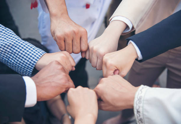 istock Diverse multiethnic Partners hands together teamwork group of multi racial people meeting join hands togetherness. Diversity people hands join empower partnership teams connection volunteer community 1337358878
