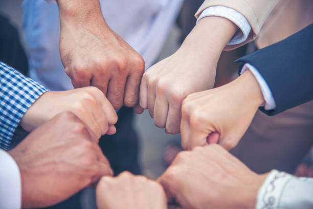 istock Diverse multiethnic Partners hands together teamwork group of multi racial people meeting join hands togetherness. Diversity people hands join empower partnership teams connection volunteer community 1337358882