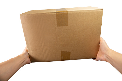 Point of view hand of courier holds the package or Parcel box delivery to the customer isolated on white