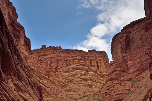 Xinjiang, Aksu region, Kuqa City,Kuqa Ten-zan Grand Canyon, \nNational 5A scenic spot.\nThe Ten-zan Grand Canyon is a reddish-brown rock formed by wind and rain over hundreds of millions of years.\nIt is about 5.5 km in depth from east to west.\nThe grand canyon is majestic, precipitous, deep, quiet and mysterious.\nThe red mountains looked like flames in the sun.