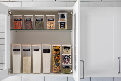 Kitchen storage organization use plastic case. Placing and sorting food products into pp box