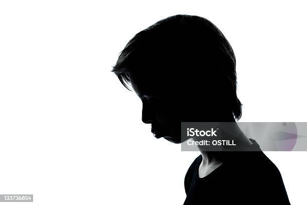 One Young Teenager Boy Or Girl Silhouette Moody Pouting Sad Stock Photo - Download Image Now