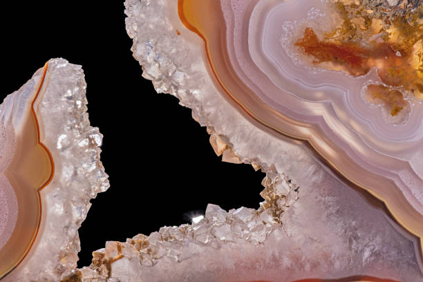 istock light orange agate with quartz crystals isolated on black 1337371882