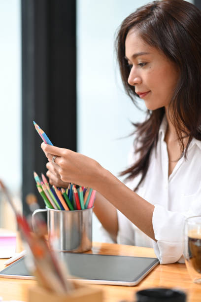 istock Side view smiling creative woman working in her art studio. 1337372221