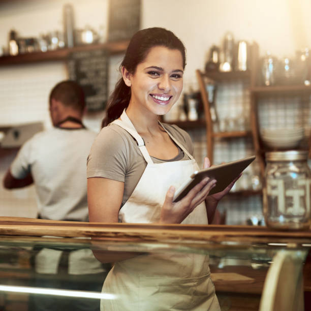 istock Shot of a young woman using a digital tablet while working in a coffee shop 1337372308