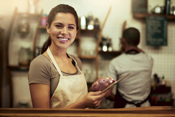 istock Shot of a young woman using a digital tablet while working in a coffee shop 1337372310