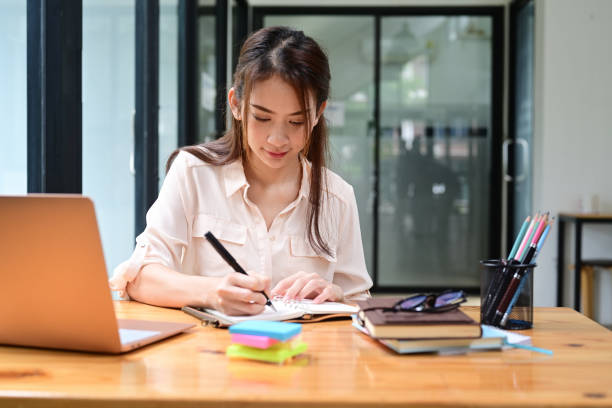 istock Asian female office worker working in modern office. 1337373098