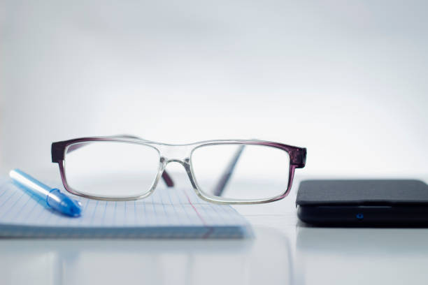 istock Workplace at office with smartphone, eyeglasses, pen and notebook paper 1337374091