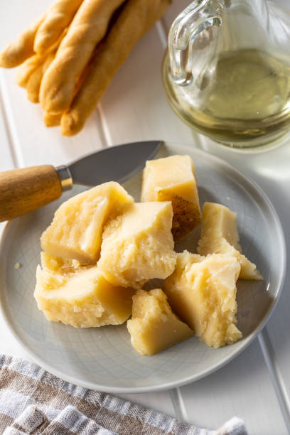 istock Block of italian parmesan cheese on kitchen table. 1337375323