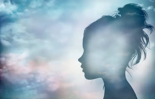 Photo of Concept of thinking - psychology - imagination - intelligence or inspiration.Character and personality metaphor.Woman face profile silhouette with sky and clouds background.Mental disorder