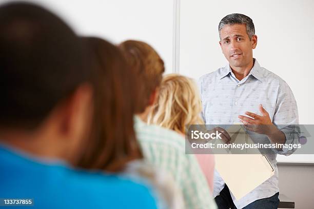 Tutor With Class Of Students Stock Photo - Download Image Now - Classroom, In Front Of, Learning