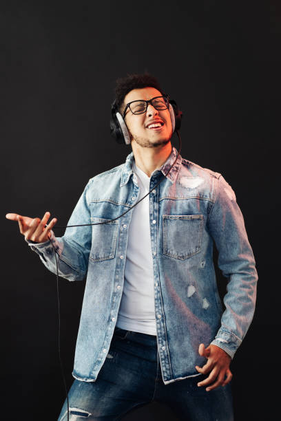 istock Carefree dark skinned guy listens lively music 1337379932