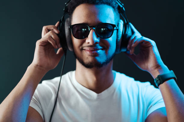 istock Carefree dark skinned guy listens lively music 1337380045