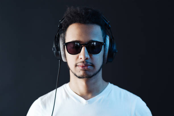 istock Carefree dark skinned guy listens lively music 1337380064