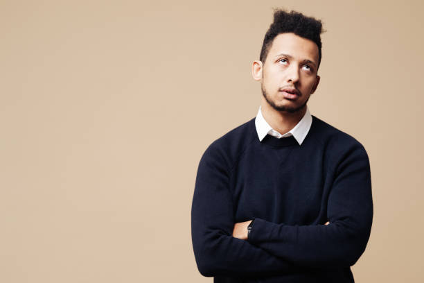 Portrait of bored man on beige background