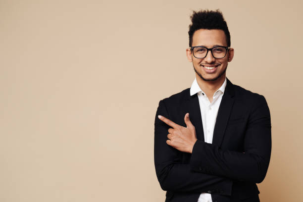 istock Handsome man pointing to the side with space for text 1337380362