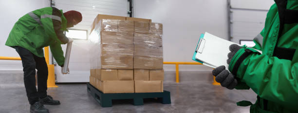 istock Staff wrapping film packaging boxes with a note at cold storage warehouse in banner, Loading goods prepare storage in the freezing room, Warehouse Storage System Service in Logistics Business concept 1337381200